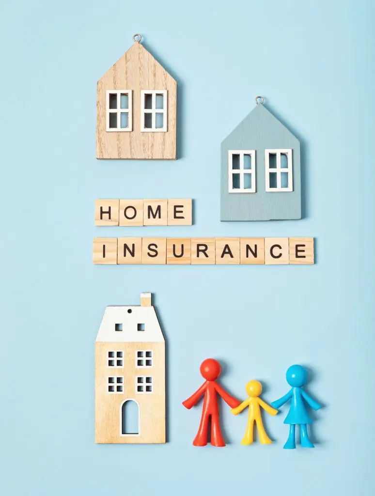 Home insurance message and wooden houses over blue background